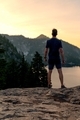 Man taking in a sunset view after running up mountain trail.  - PhotoDune Item for Sale