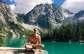 Man doing yoga at emerald green glacier fed alpine lake in summer.  - PhotoDune Item for Sale