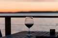 Red wine on seaside deck at sunset.  - PhotoDune Item for Sale