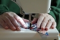 Close up of seamstress sewing at a sewing machine. - PhotoDune Item for Sale