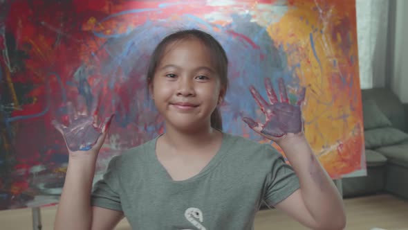 Young Girl Shows Her Dirty Hands During Painting Art