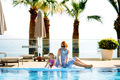 Mother and daughter having a fun near swimming pool in summer.  - PhotoDune Item for Sale