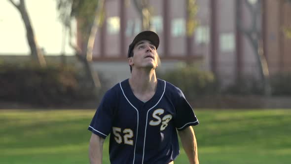 A young man playing catch with a baseball.