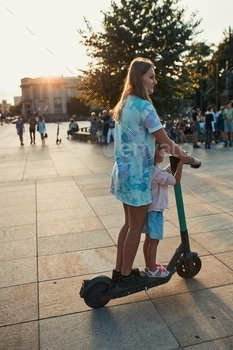 electric scooter in the city center. Concept of happy family. Candid people, real moments, authentic situation