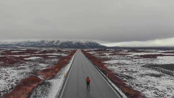 Aerial view of woman in road in terrain snowy