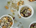 Runners snack on table full of nuts and seeds at marathon  - PhotoDune Item for Sale