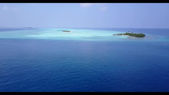 Aerial panorama of marine lagoon beach lifestyle by turquoise ocean and white sandy background of a 