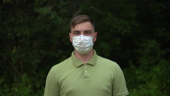 The Young Man Takes Off His Medical Mask and Throws It Away