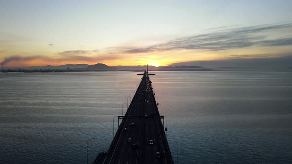 Aerial silhouette of car traffic move at Penang Bridge