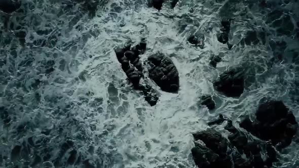 Ocean Waves Arrive And Beat Against The Rocks Top View alt