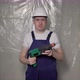 Builder in Blue Overalls and White Hard Hat Helmet and Glasses with Perforator - VideoHive Item for Sale