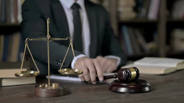 Close Up Shoot of Judge Hand Banging the Gavel on Court Room Table