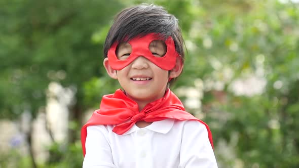 Asian Child In In Superhero Costume Playing In The Park Slow Motion