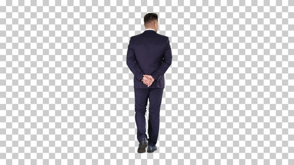 Businessman walking and looking around holding hands behind
