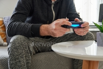  gontroller, using technology, lifestyle, home, couch, playing games, video games, playstation, xbox, person, mid-section, unrecognizable person, real people.