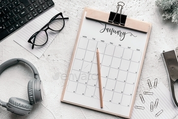 board and headphones in frame. Pencil on calendar on bright background