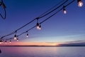 Hanging deck lights at sunset by the sea.  - PhotoDune Item for Sale