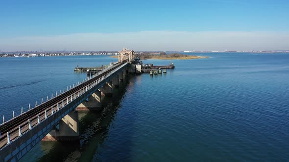 A drone shot over Grassy Bay in Queens, NY. The camera dolly in along the length of the elevated tra