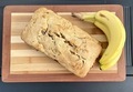 Homemade banana bread with fresh bananas on a handmade wood cutting board  - PhotoDune Item for Sale