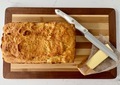 Fresh baked bread and butter on wooden cutting board viewed from above - PhotoDune Item for Sale