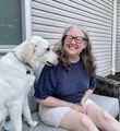 Woman laughs as her Labrador retriever dog acts silly, sticking tongue out. - PhotoDune Item for Sale
