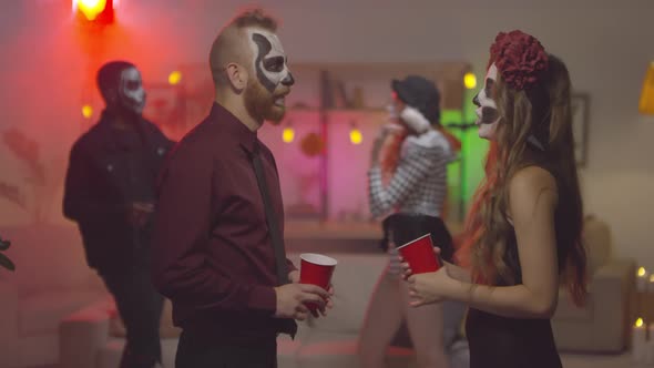 Slowmo of People in Halloween Costumes Chatting at Party