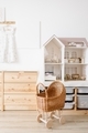 Cozy interior of a children's room, a play area. A chest of drawers, doll house, doll strollers - PhotoDune Item for Sale
