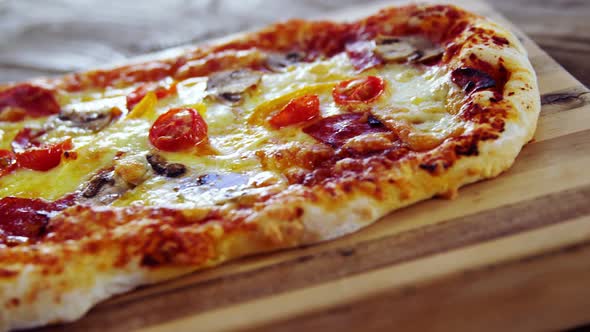 Baked pizza on wooden board