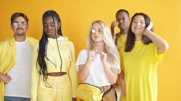 Confident Diverse Multiethnic Group of People Stand Together Isolated on Yellow Background