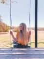 Beautiful blonde girl with long hair sitting on swing  - PhotoDune Item for Sale