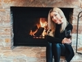 Beautiful blonde girl drinking wine near fireplace  - PhotoDune Item for Sale