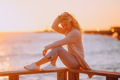 Beautiful blonde traveler girl with long hair enjoying sunset at the beach in Australia - PhotoDune Item for Sale