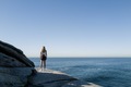 Woman standing on the cliff alone overlooking the ocean in Sydney - PhotoDune Item for Sale