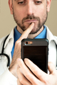 Doctor reading or video chatting on phone device.  - PhotoDune Item for Sale