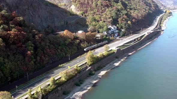 Commuter Train Passing Through a River Valley