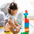 Diverse toddler girl at home having fun with colorful mega blocks, learning, development  - PhotoDune Item for Sale
