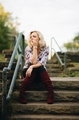 Young blonde millennial girl sitting on stairs in deep thought  - PhotoDune Item for Sale