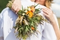 Wedding bouquet in boho style on the background of nature. The bride holds a bouquet of dried flower - PhotoDune Item for Sale