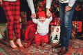 Family for christmas. Red Christmas decor, family photo. Dad, mom and baby in red and white clothes. - PhotoDune Item for Sale