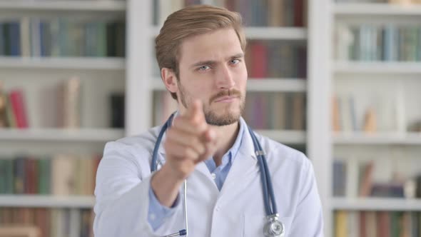 Portrait of Doctor Pointing Towards Camera