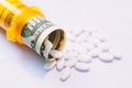 Pills coming out of pill bottle with twenty dollar bill, cost of medication concept  - PhotoDune Item for Sale