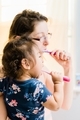Mother and diverse daughter in bathroom brushing teeth  - PhotoDune Item for Sale