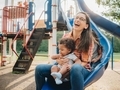 Young mother having fun at the park on a slide with her children  - PhotoDune Item for Sale