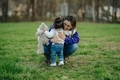 Mother hugging daughter with stuffed animal at park - PhotoDune Item for Sale