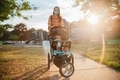 Mother with mixed race children at take a stroll through a playground at sunset, mother wearing mask - PhotoDune Item for Sale