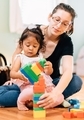 Young millennial mother at home with diverse daughter playing with colorful building blocks  - PhotoDune Item for Sale