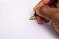 African American man writing with ballpoint pen on white paper  - PhotoDune Item for Sale