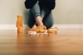 Woman sitting on floor in front of a bunch of open pill bottles  - PhotoDune Item for Sale