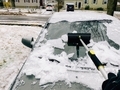Man scraping snow and ice off car window after blizzard - PhotoDune Item for Sale