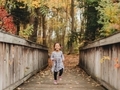 Diverse girl happily running towards the camera on a colorful fall day - PhotoDune Item for Sale
